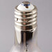 A close up of a Satco high-pressure sodium light bulb with a silver base.