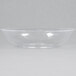 A close-up of a clear Fineline bowl on a white surface.