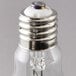 A close up of a Satco metal halide light bulb with a silver base.