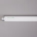 A Satco fluorescent tube light with a white rectangular body and gold tip.