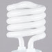 A close-up of a white spiral Satco compact fluorescent light bulb.