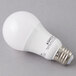 A Satco frosted warm white multi-directional LED light bulb on a gray surface.