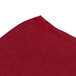 A burgundy fabric with a seam.