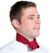 A man in a chef's uniform wearing a burgundy chef neckerchief.