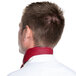 The back of a man wearing a burgundy chef neckerchief with a red collar.