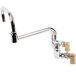 A T&S stainless steel wall mount faucet with double joint and two handles.