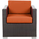 A BFM Seating Aruba wicker armchair with rust canvas cushions on a white background.