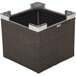 A BFM Seating Aruba Java wicker end table with a brown basket with metal corners on top.