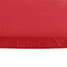 A Creative Converting Stay Put Real Red round plastic tablecloth with elastic on a table.