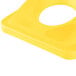 A yellow rectangular plastic lid with a circle in the middle.