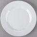 A white Minski melamine plate with a textured rim on a gray surface.