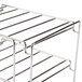 A metal rack with metal rods on two shelves.