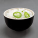 A round two-tone melamine bowl with ebony exterior and sand interior filled with rice, jalapenos, and green onions.