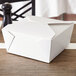 A white Fold-Pak Bio-Pak take-out box with a lid on a table.