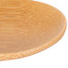 A close up of a Tablecraft bamboo round dish.
