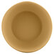An Elite Global Solutions rattan-colored melamine bowl with a close-up of a circular object.