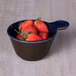 An Elite Global Solutions Durango lapis and chocolate two-tone melamine bowl filled with strawberries on a wooden table.