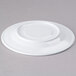 A white Elite Global Solutions melamine coffee saucer with a small rim.