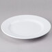 An Elite Global Solutions white melamine plate with a small rim on a gray surface.