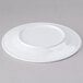 A white Elite Global Solutions melamine plate with a small rim.