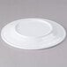 A white Elite Global Solutions melamine platter with a small rim.