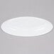 An Elite Global Solutions white melamine oval plate on a gray surface.