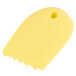 A yellow silicone spatula with a graduated saw tooth edge.