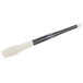 A close-up of a black and white Mercer Culinary round arch silicone brush with a black handle.