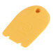 A yellow plastic Mercer Culinary horseshoe-shaped plating tool with a hole.