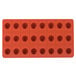 A red silicone Martellato mold with 24 round compartments.