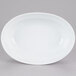 A white oval serving bowl with a white rim.