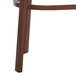 The wood grain leg of a Lancaster Table & Seating barstool.