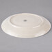 An ivory ceramic platter with a circular design on it.