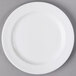 A Libbey Slenda white porcelain plate with a white rim on a gray surface.