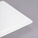 A white rectangular porcelain tray with rounded corners on a gray surface.