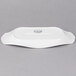 A white rectangular porcelain platter with fluted edges and a handle.