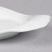 A close-up of a Libbey white porcelain platter with curved edges.