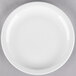 A Libbey white porcelain plate with a white rim on a gray surface.