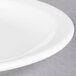 A close-up of a Libbey white porcelain plate with a narrow white rim.