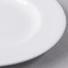 A close up of a Libbey white porcelain plate with a wide white rim.