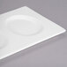 A white rectangular porcelain tray with three circular wells.