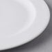 A close up of a Libbey white porcelain plate with a white rim.
