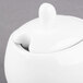 A white ceramic Libbey sugar pot with a lid.