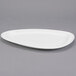 A close-up of a white Libbey Triform Royal Rideau porcelain plate with a white rim.