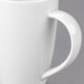 A close-up of a white Libbey porcelain mug with a handle.