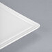 A close-up of a Libbey white porcelain square plate corner with a thin edge.