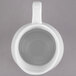 A white rectangular Libbey porcelain creamer with a black handle.