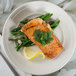 A Tuxton Hampshire china plate with salmon, green beans, and a lemon wedge.