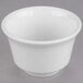 A close-up of a Libbey Royal Rideau white porcelain bouillon bowl on a gray surface