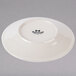 A white Tuxton Hampshire china bread and butter plate with black embossed text.